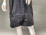 an image of a mannequin wearing a black dress with ruffles