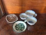 many bowls and bowls sitting on a wooden table