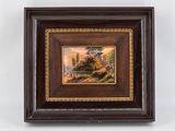 framed picture of a painting of a river scene in a wooden frame