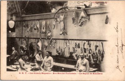 une vieille photo montrant un groupe de personnes dans une boucherie