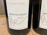 two bottles of wine that are sitting on a table