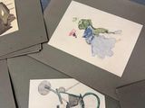 several cards with drawings of people on them on a blue surface