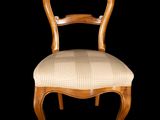 an image of a wooden chair with a checkered seat on a black background