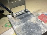 a metal platform with a mirror on top of it