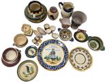 many different types of plates and bowls on the table