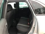 the back seat of a car with the door open and a seat belt down