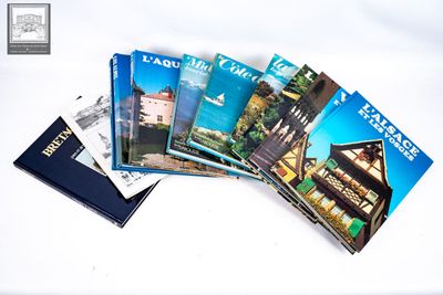 several travel books are stacked on top of each other on a white surface