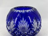 a blue glass bowl with a lid and a small bowl on the table