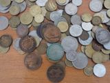 a pile of coins sitting on a wooden table