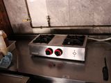 a stove top with two burners on it in a kitchen