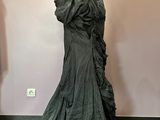 two mannequins in a room with a dress on a mannequin stand