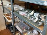 many shelves with various items on them in a room