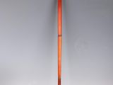 an old wooden baseball bat with a red handle on a white surface