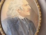 portrait of a man with white hair in a brown frame