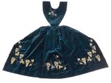 a green velvet dress with gold embroidered flowers on it