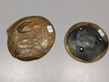 two pieces of pottery that are on a table