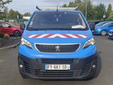 une petite camionnette bleue garée sur un parking