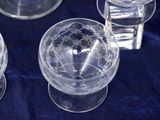 three clear glass vases sitting on top of a blue table cloth