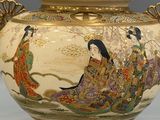 a vase with a lid that has a painting on it