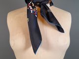 a woman ' s neck scarf on a mannequin mannequin torso