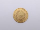 a gold coin on a white surface with a white background