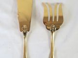 two forks and a knife on a white table