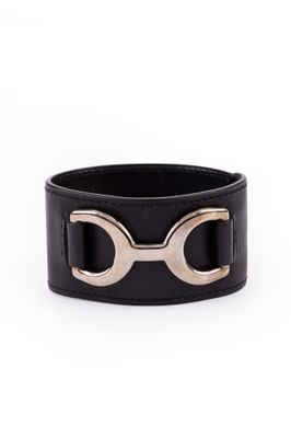 a black leather bracelet with two horseshoes on it