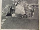 a black and white photo of a man sitting in an airplane