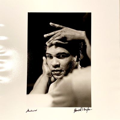 a black and white photo of a man with his hands on his face