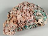 pink, green and white mineral on a white surface