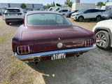 an image of a maroon car parked in a parking lot