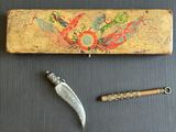 un couteau, un stylo et un étui posés sur une table