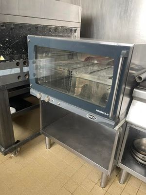 a small oven sitting in the middle of a kitchen