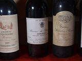 several bottles of wine are lined up on a red table