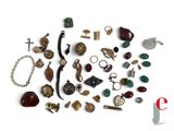 a pile of assorted jewelry on a white surface