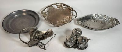 silver plated dishes and spoons on a white surface