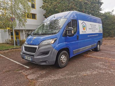 a blue van that is parked in a parking lot