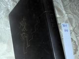 a black book sitting on a bed with a price tag on it
