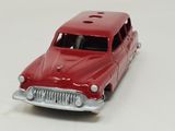 a red toy car that is sitting on a white surface