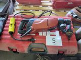 a red box with tools on top of it on a table