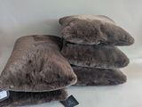 three pillows are stacked on top of each other on a white surface