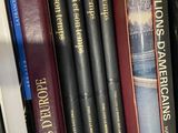 many books that are on a book shelf together