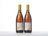 two bottles of wine sitting on top of a table