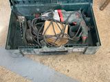 a green box with tools in it sitting on the floor