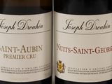 several bottles of wine are lined up on a shelf