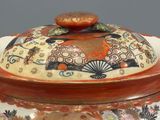 a large vase with a lid that has a design on it