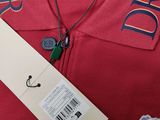 a close up of a red polo shirt with a tag on it