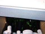 bottles of wine sit in a cardboard box on a counter