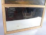 a picture of a mirror with a chair in the reflection