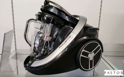 un mixeur noir et argent exposé dans une vitrine en verre